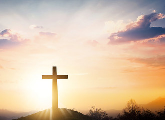 Christmas concept: The cross on mountain sunset background