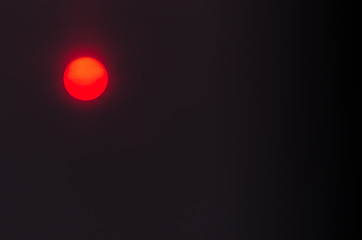 Close-Up of Red Sun Circle In Hazy City Air. Pollution, Climate Change Concept.