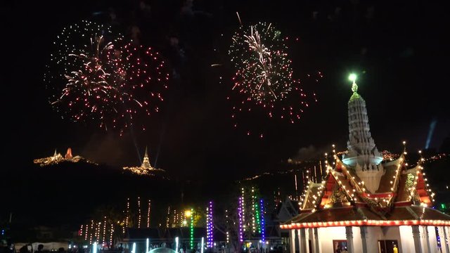 Firework display ,4K video. The most famous firework Pra Nakorn Kiri festival  Thailand with Petchaburi Lak muang hall  in  foreground and three pagodas on the hill in background.
