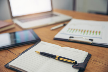 Planner and Agenda Concept.Desktop laptop,tablet and annual report  place on office desk.Notebook and smartphone for Planner to set timetable,agenda,appointment,organization,management ein meeting roo