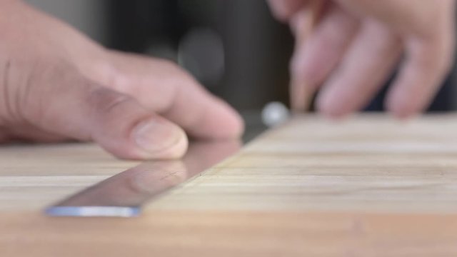 Carpenter use pencil Drawing a Line along the ruler,  Pencil draw a line  on the wood