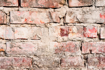Texture of a brick wall with cracks and scratches which can be used as a background