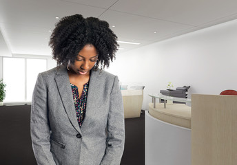 Black African American businesswoman in an office looking sad or depressed.  She is an owner or an...