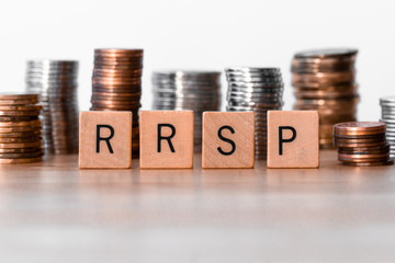 RRSP (Registered Retirement Savings Plan) signs with coins in the background