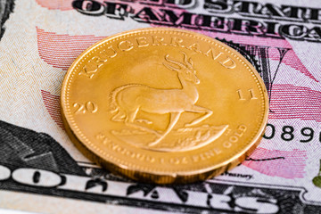 Krugerrand gold ounce on dollar banknote