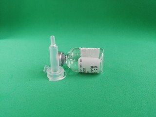 Minsk Republic of Belarus July 30 2019 a small new jar of medicine with a tube of dropper on a green background shot with real natural close-up photography