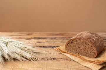 Sliced black bread on the old wooden plank.
