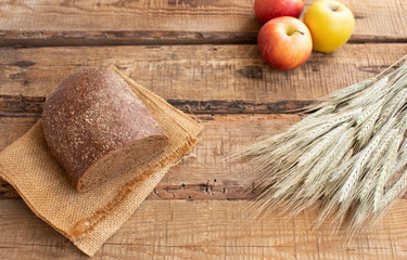 Sliced black bread on the old wooden plank.