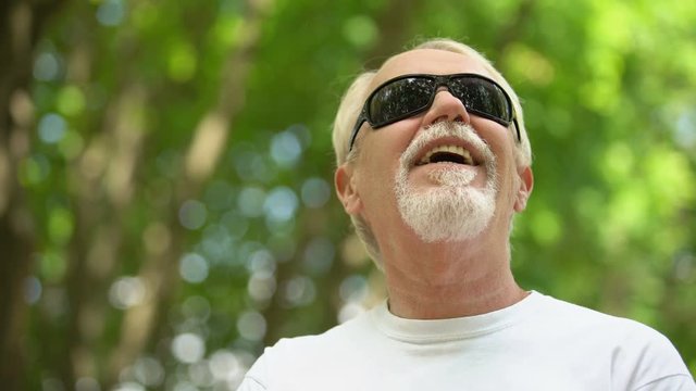 Visually Impaired Man In Sunglasses Listening Nature Sounds, Heightened Senses