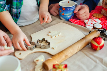 mom and son prepare Christmas cookies for Christmas