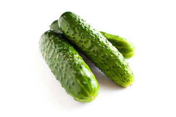 small gherkins, delicious fresh cucumbers on a white background 