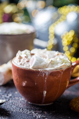 hot cocoa with marshmallows, cream and cookies on holiday christmas background