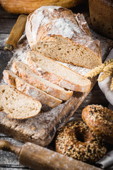 Fresh homemade slice bread and knife on rustic table
