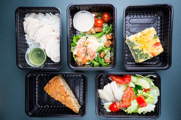 Healthy food delivery. Take away food for diet. Fitness nutrition, balanced proteins, fats and carbohydrates in plastic boxes. Top view, flat lay.