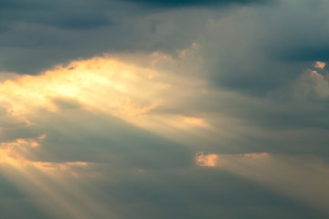 Dramatic picturesque colorful skies with cloud and picturesque sunbeams before sunset