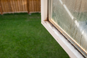 A dirty, moldy window before being cleaned.