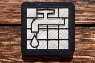 washable dir pollen hepa filter from vacuum cleaner with water tap icon on the wooden floor