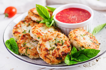 Delicious rice and chicken meat patties with garlic tomato sauce. Diet food.