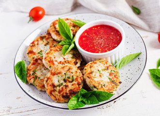 Delicious rice and chicken meat patties with garlic tomato sauce. Diet food.