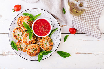 Delicious rice and chicken meat patties with garlic tomato sauce. Top view. Diet food. Copy space