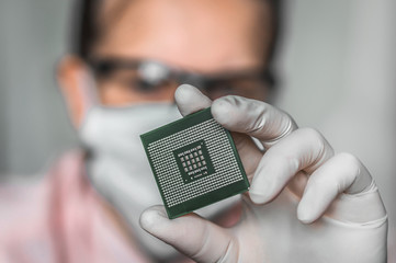 Scientist showing the computer microchip before repairs electron