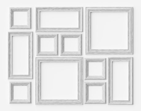 White wood photo or picture frames on white wall with shadows