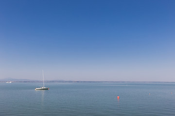Small boat sailing on Trasimeno lake, Italy