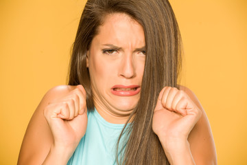  young disgusted woman on yellow background
