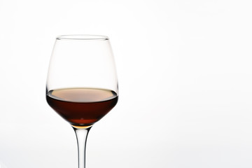 Glass of red wine on white background close-up