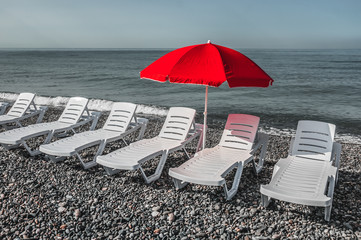 Sun umbrella and beach beds on the shingle beach