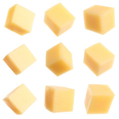 Set of delicious cheese cubes on white background