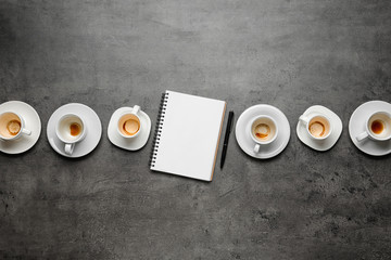 Flat lay composition with empty cups and blank notebook on grey table