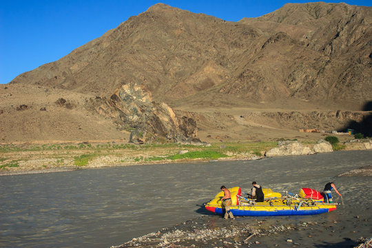 Participants of the extreme rafting moored to the shore. Chilik River, Kazakhstan.