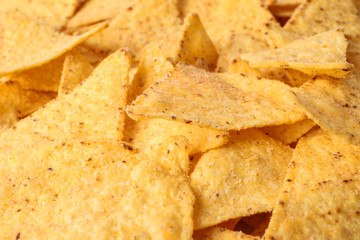 Tasty Mexican nachos chips as background, closeup