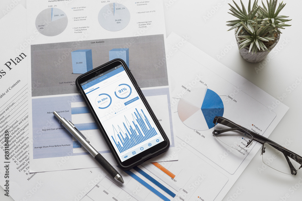 Aufkleber top view of office desk table with graph chart on mock up smartphone on white desk table. business m