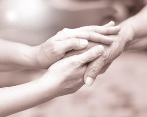 Fototapeta na wymiar Caregiver, carer hand holding elder hand in hospice care. Philanthropy kindness to disabled concept.