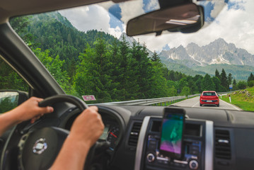 view from car inside navigation on phone mountains on background