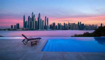 Schilderijen op glas Skyline van Dubai Marina bij een prachtige zonsondergang met een overloopzwembad ervoor © Cara-Foto