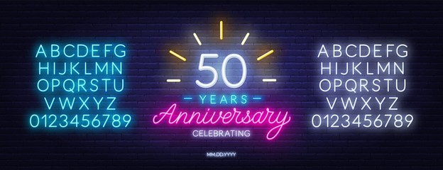 Fifty years anniversary celebration neon sign on a dark background.