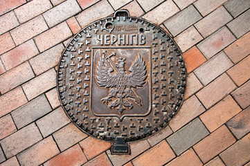 Chernihiv / Ukraine - 07/04/2019: Sewer hatch with Chernihiv coat of arms and city name