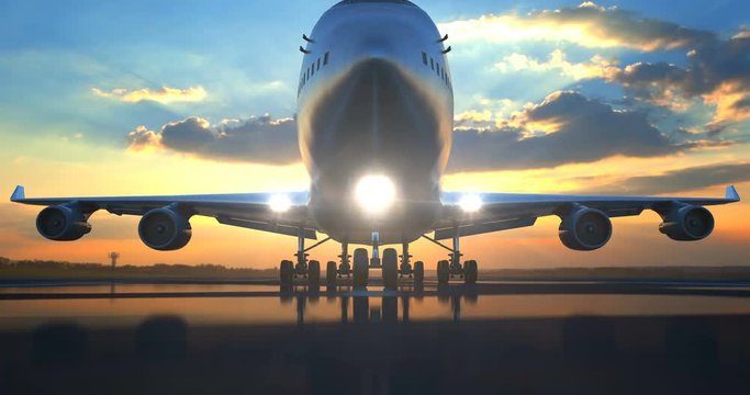 Large passenger airplane rolling along wet runway over camera against scenic sunset