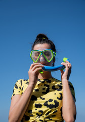 Young woman wearing snorkel mask on the beach