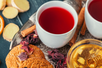 Cup of freshly brewed fruit and herbal tea, dark mood.Tea ceremony