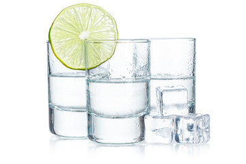 Three  tequila shots with lime isolated on white background