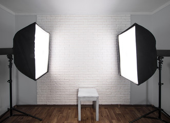 Interior of modern photo studio with  professional equipment ,white brick wall background