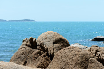 Closeup view of sea stone on a background of blue sea