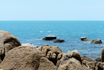 Closeup view of sea stone on a background of blue sea