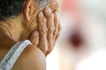 Old woman hand on face feeling toothache