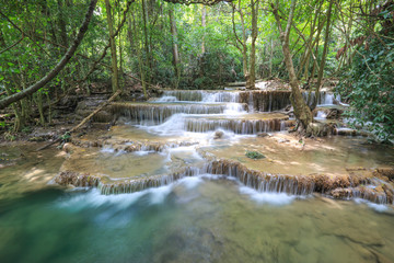 Naklejka premium water fall in nature with green trees in Kanchanaburi, Thailand
