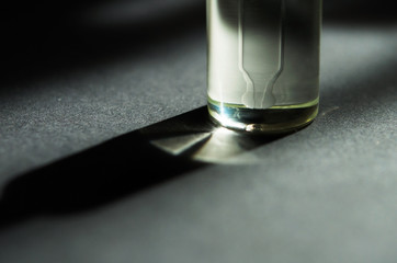 Cosmetic or medical glass bottle with pipette. Skin care concept. Natural hard light, deep shadows. - Image